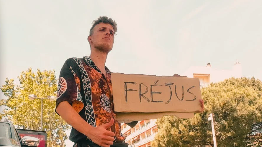 Paolo by the roadside with a sign for Fréjus